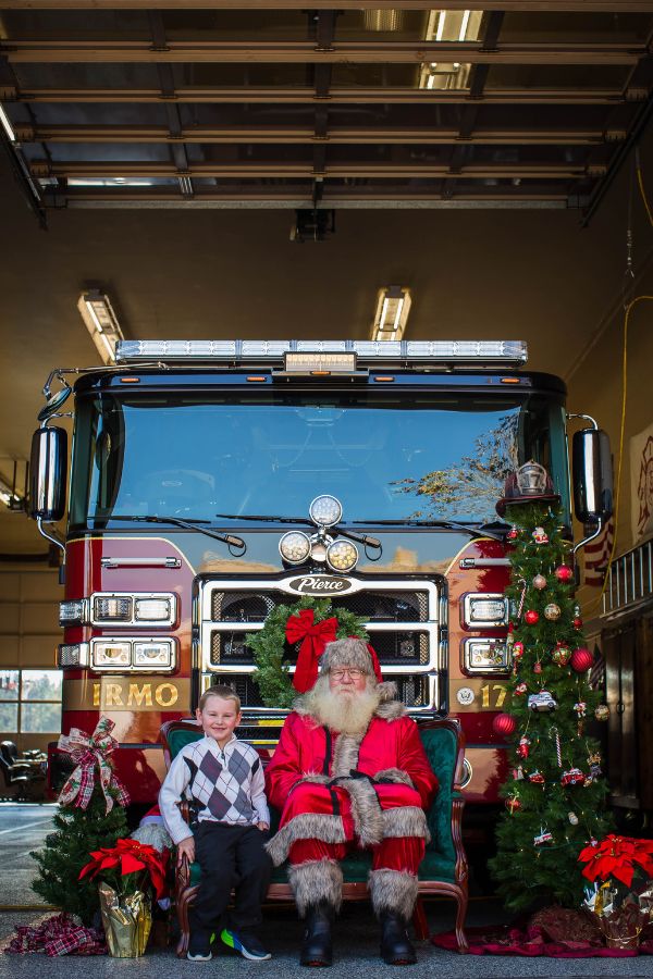 Brothers with Santa in front of Fire Engine.